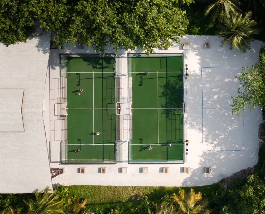 Aerial view of padel courts at a tropical venue